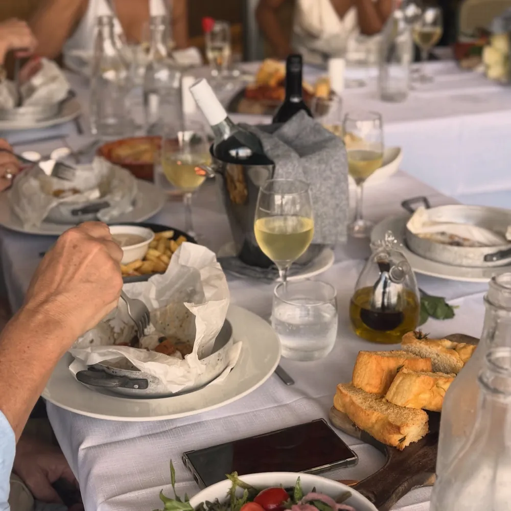 A long table of guests at Vitalia's, sharing plates