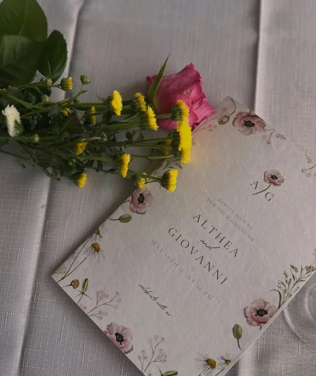 The printed menu on the table on the day, beside fresh flowers