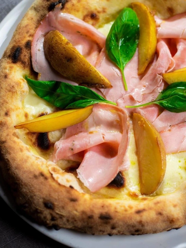 Prosciutto cotto, pear and basil, a contemporary topping at Vitalia's