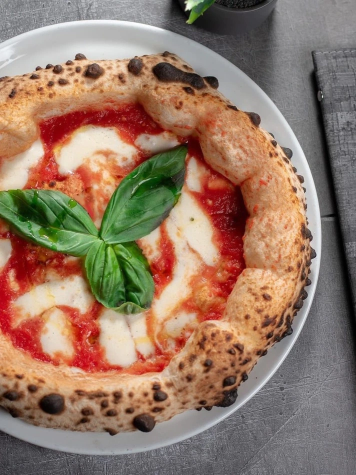 Classic Margherita with fresh basil and a leopard-spotted crust